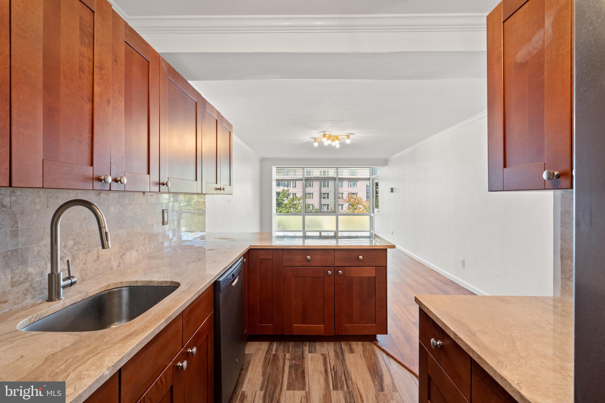 730 24th Street Northwest, Unit 503 Washington, DC 20037 - Photo 2 of 18 a kitchen with granite countertop a sink a counter space and cabinets