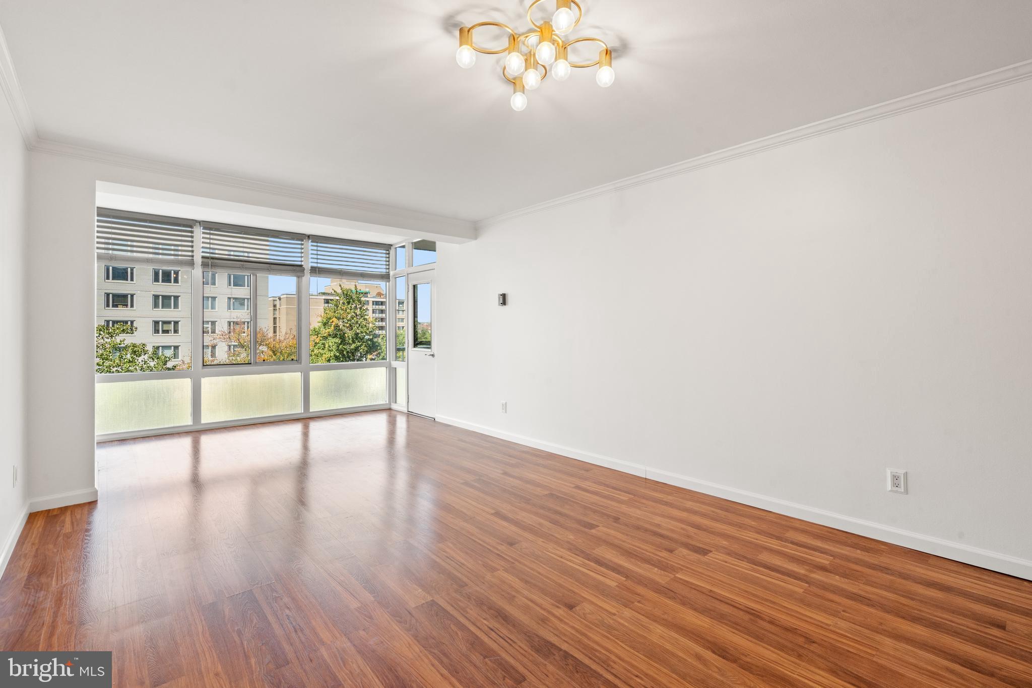 730 24th Street Northwest, Unit 503 Washington, DC 20037 - Photo 6 of 18 a view of an empty room with wooden floor and a window