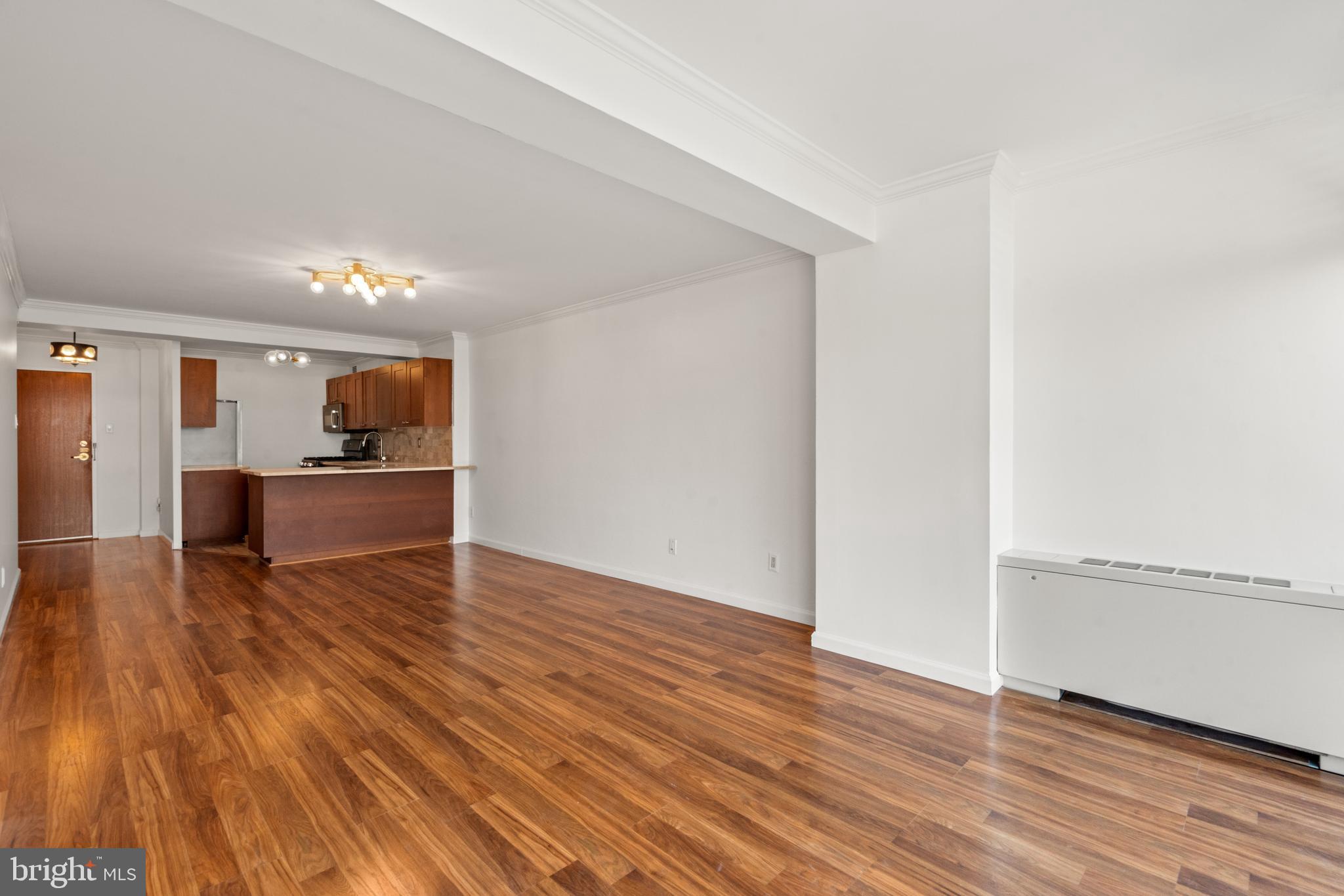730 24th Street Northwest, Unit 503 Washington, DC 20037 - Photo 7 of 18 a view of kitchen with livingroom and wooden floor