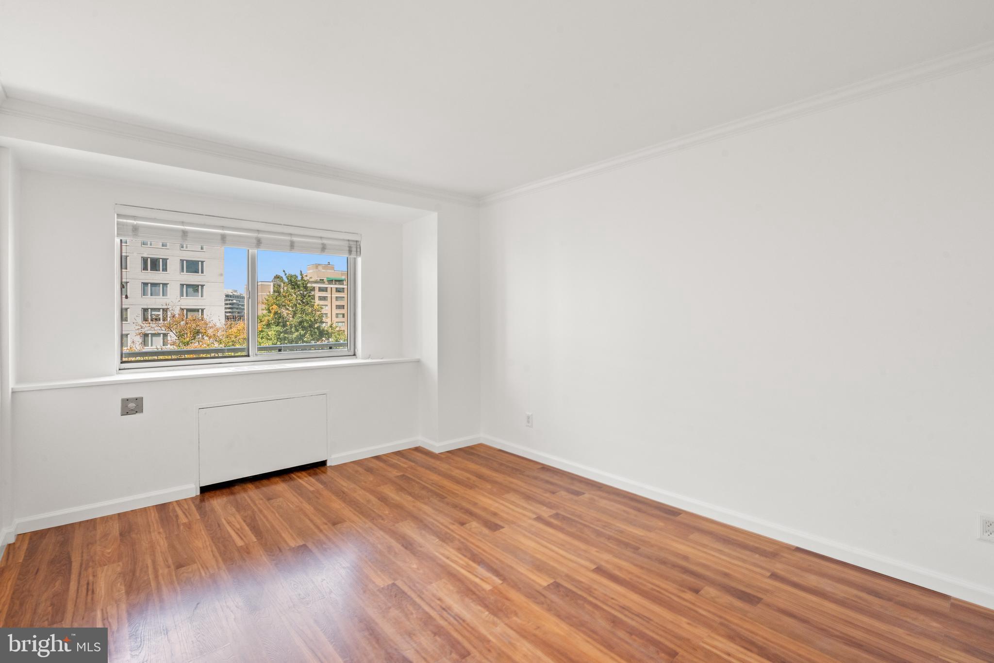 730 24th Street Northwest, Unit 503 Washington, DC 20037 - Photo 9 of 18 an empty room with wooden floor and windows