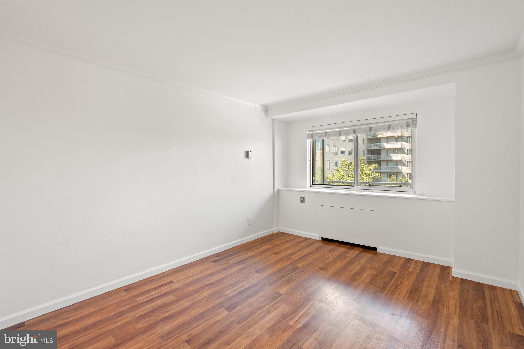 730 24th Street Northwest, Unit 503 Washington, DC 20037 - Photo 10 of 18 an empty room with wooden floor and windows