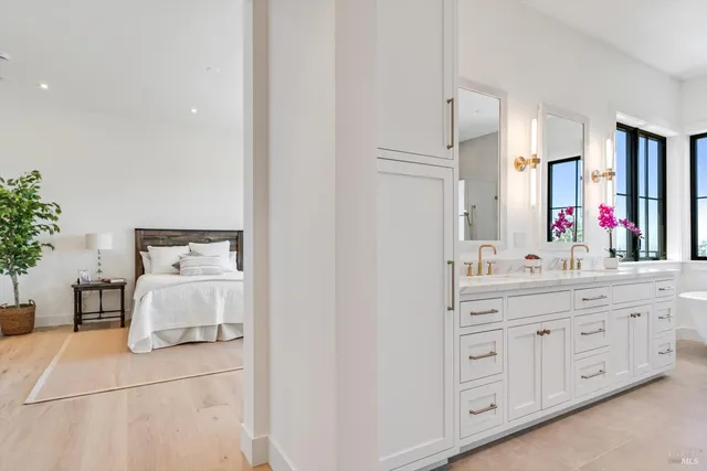 a bathroom with a double vanity sink mirror and