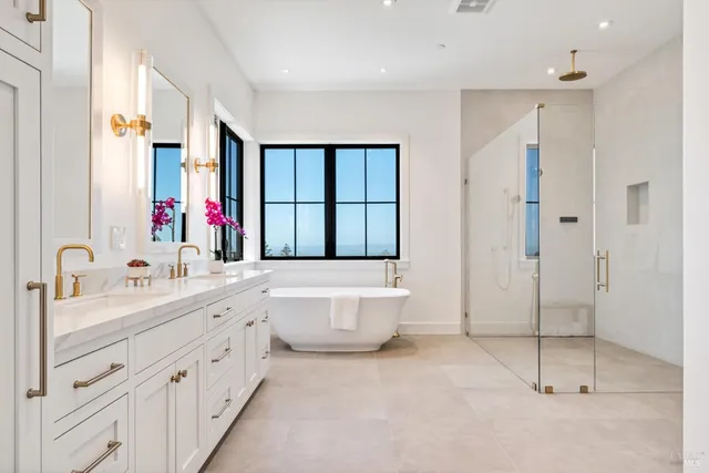 a bathroom with a double vanity sink mirror and shower