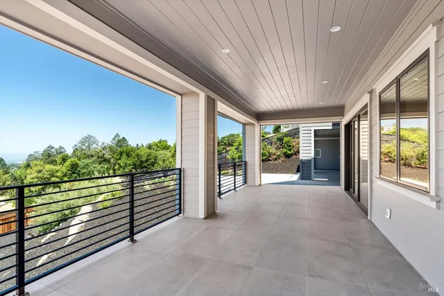 a view of a room with wooden floor and iron stairs