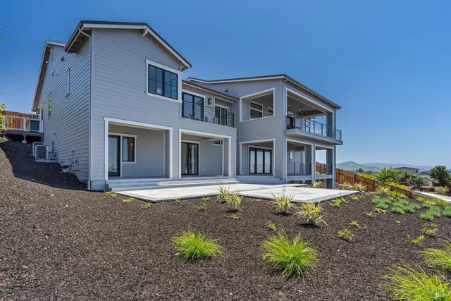a backyard of a house with table and chairs