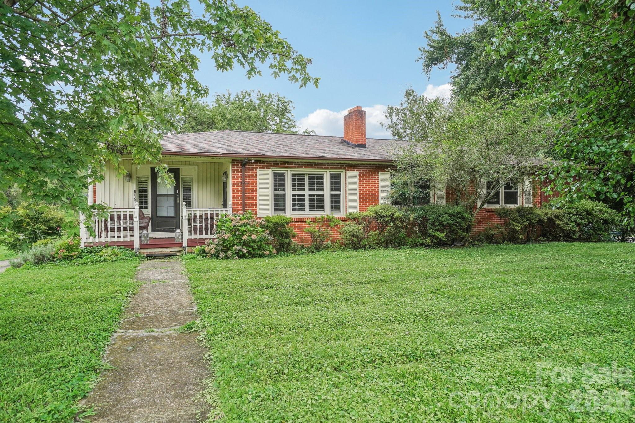 8061 Highway 70 Old Fort, NC 28762 - Photo 1 of 37 a front view of a house with a garden