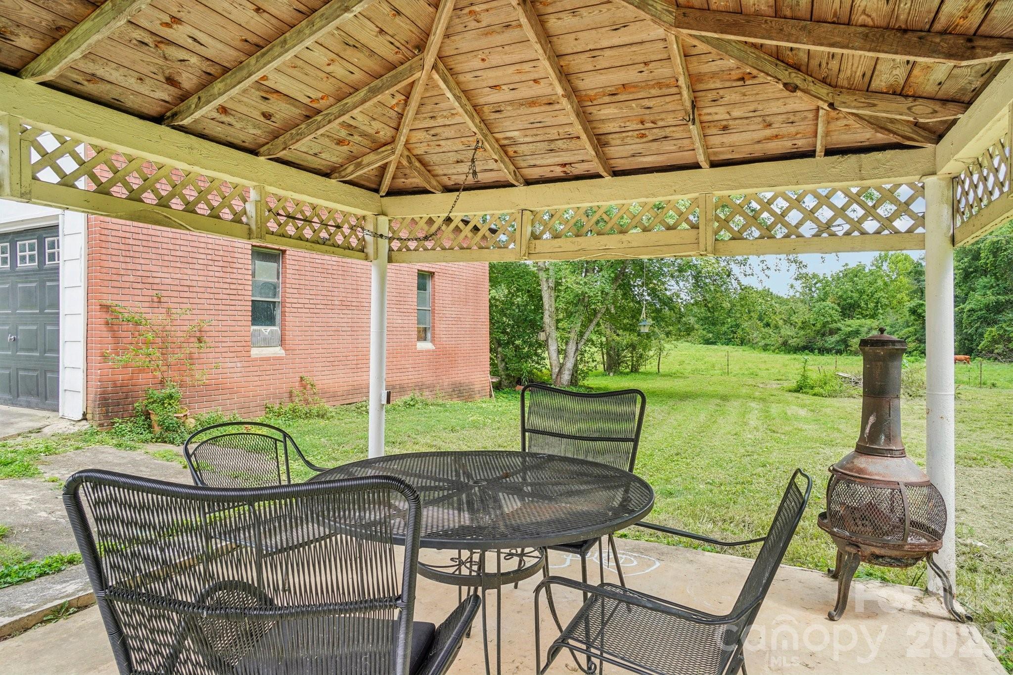 8061 Highway 70 Old Fort, NC 28762 - Photo 26 of 37 a backyard of a house with table and chairs