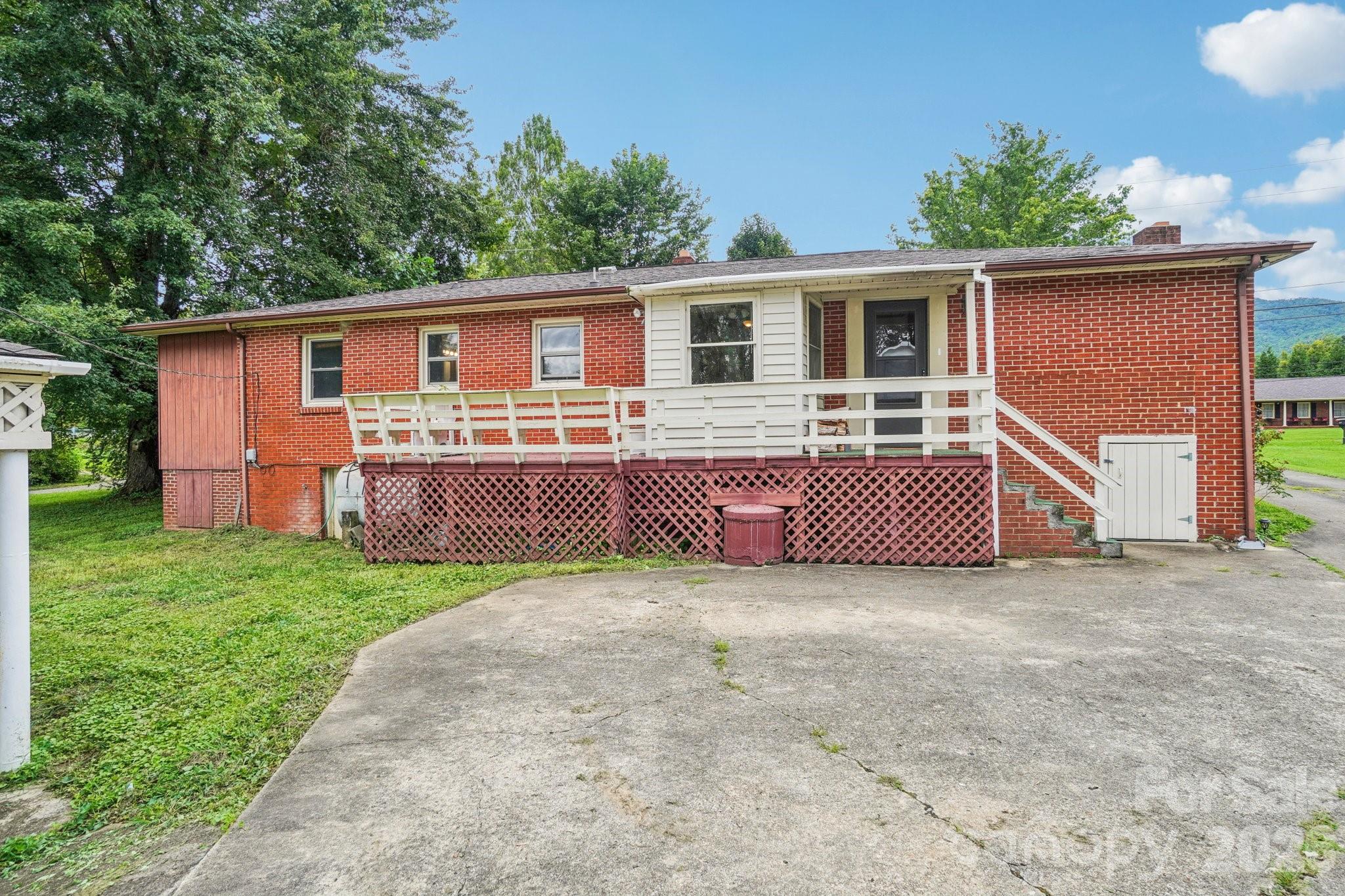 8061 Highway 70 Old Fort, NC 28762 - Photo 29 of 37 a view of a house with a yard and a large tree