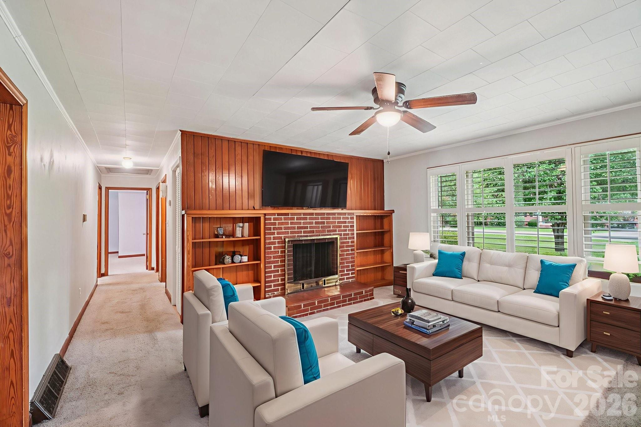 8061 Highway 70 Old Fort, NC 28762 - Photo 7 of 37 a living room with furniture a fireplace and a flat screen tv