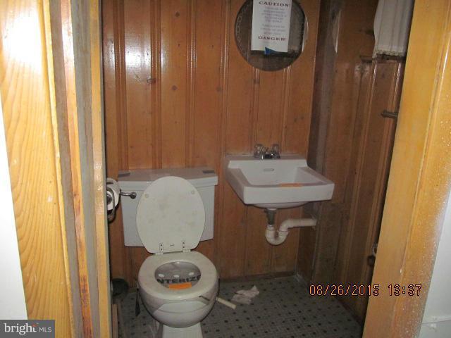 109 South Bend Road Glen Burnie, MD 21060 - Photo 11 of 21 a bathroom with a toilet sink and mirror