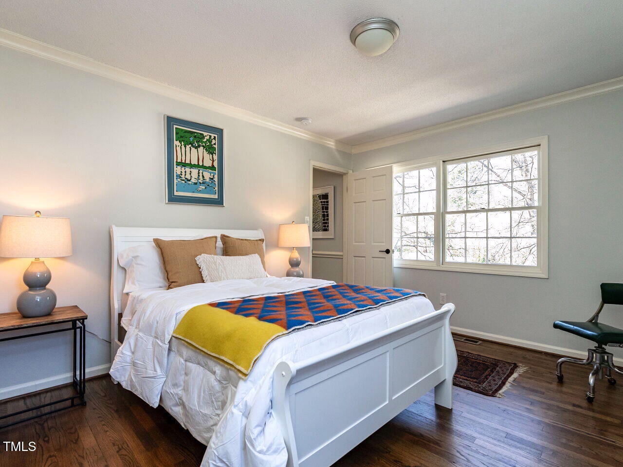 7416 Fiesta Way Raleigh, NC 27615 - Photo 16 of 27 a bedroom with a bed and wooden floor