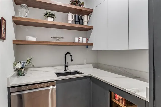 a kitchen with kitchen island a sink stove and cabinets