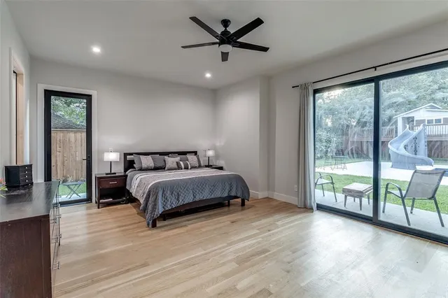 a spacious bedroom with a large bed and a large window