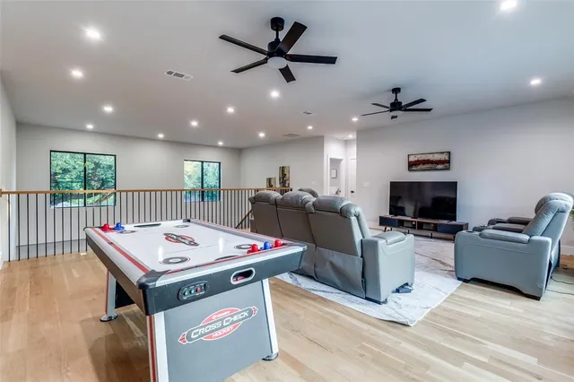 a living room with furniture a flat screen tv and a table
