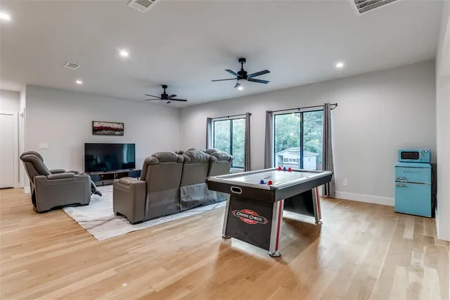 a living room with furniture a wooden floor and a fireplace