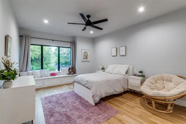 a living room with a bed and a large window