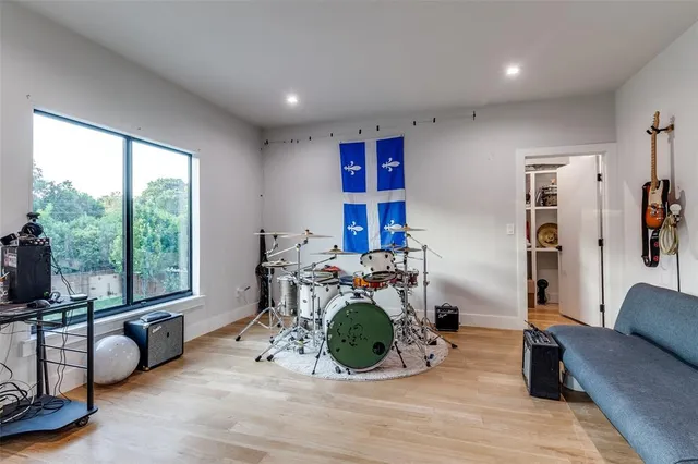 a living room with furniture a window and a flat screen tv