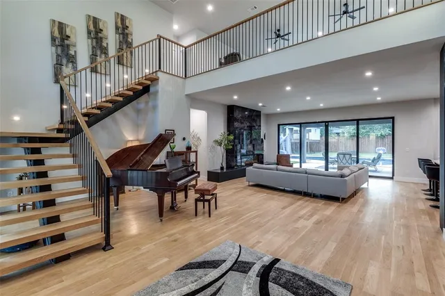 a living room with furniture and wooden floor