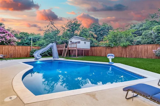 a view of swimming pool with lounge chair