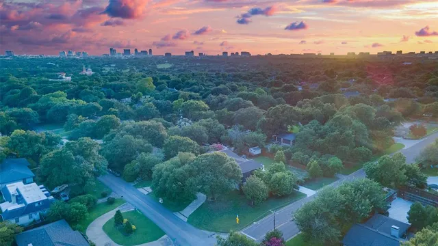 an aerial view of a house with a garden and lake view
