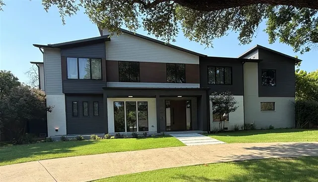 a house that has a tree in front of it