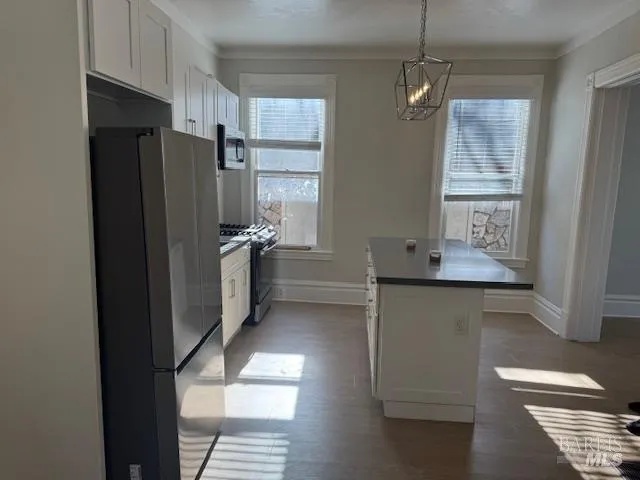 a kitchen with stainless steel appliances a refrigerator and a stove