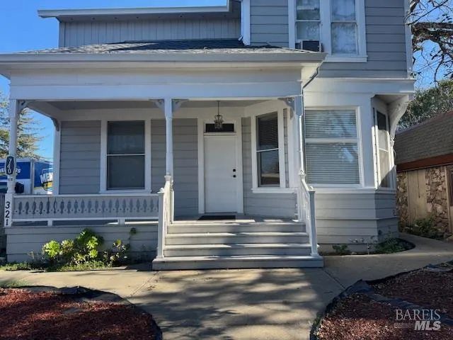 a front view of a house with a garden