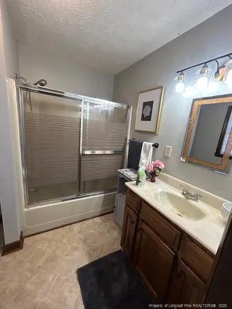 a bathroom with a sink mirror toilet and shower
