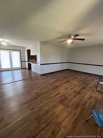 a view of a room with wooden floor