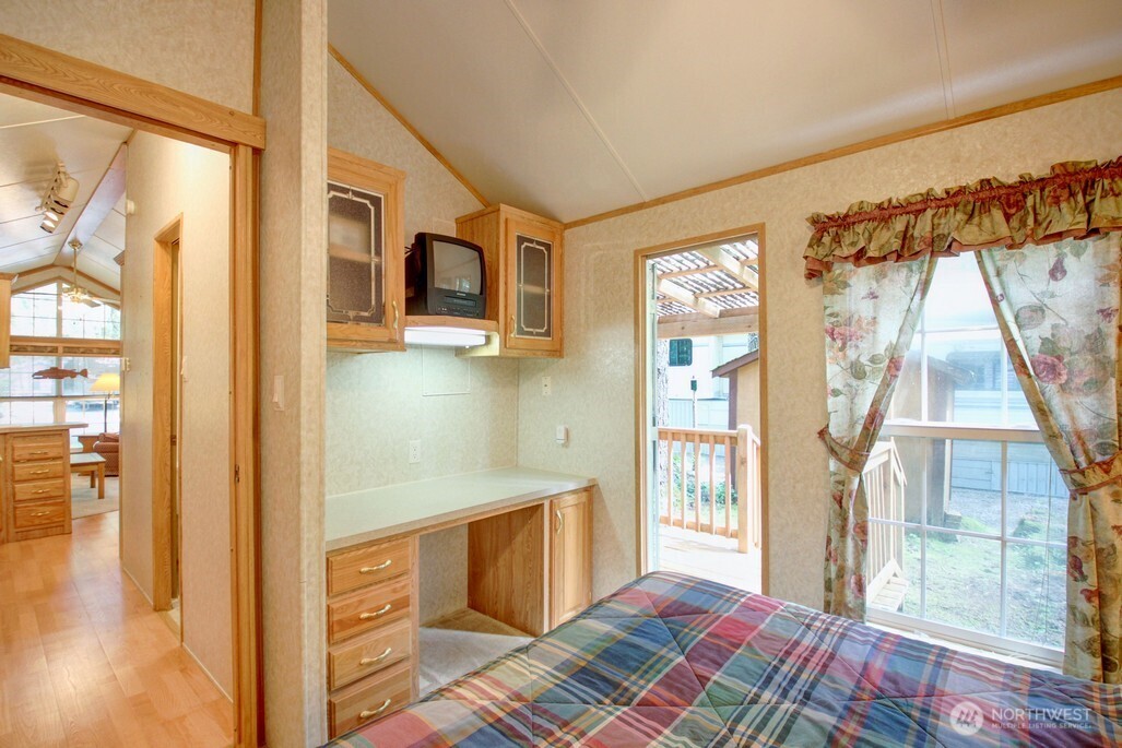 134 Drial Loop Maple Falls, WA 98266 - Photo 16 of 36 a spacious bedroom with a bed and wooden floor