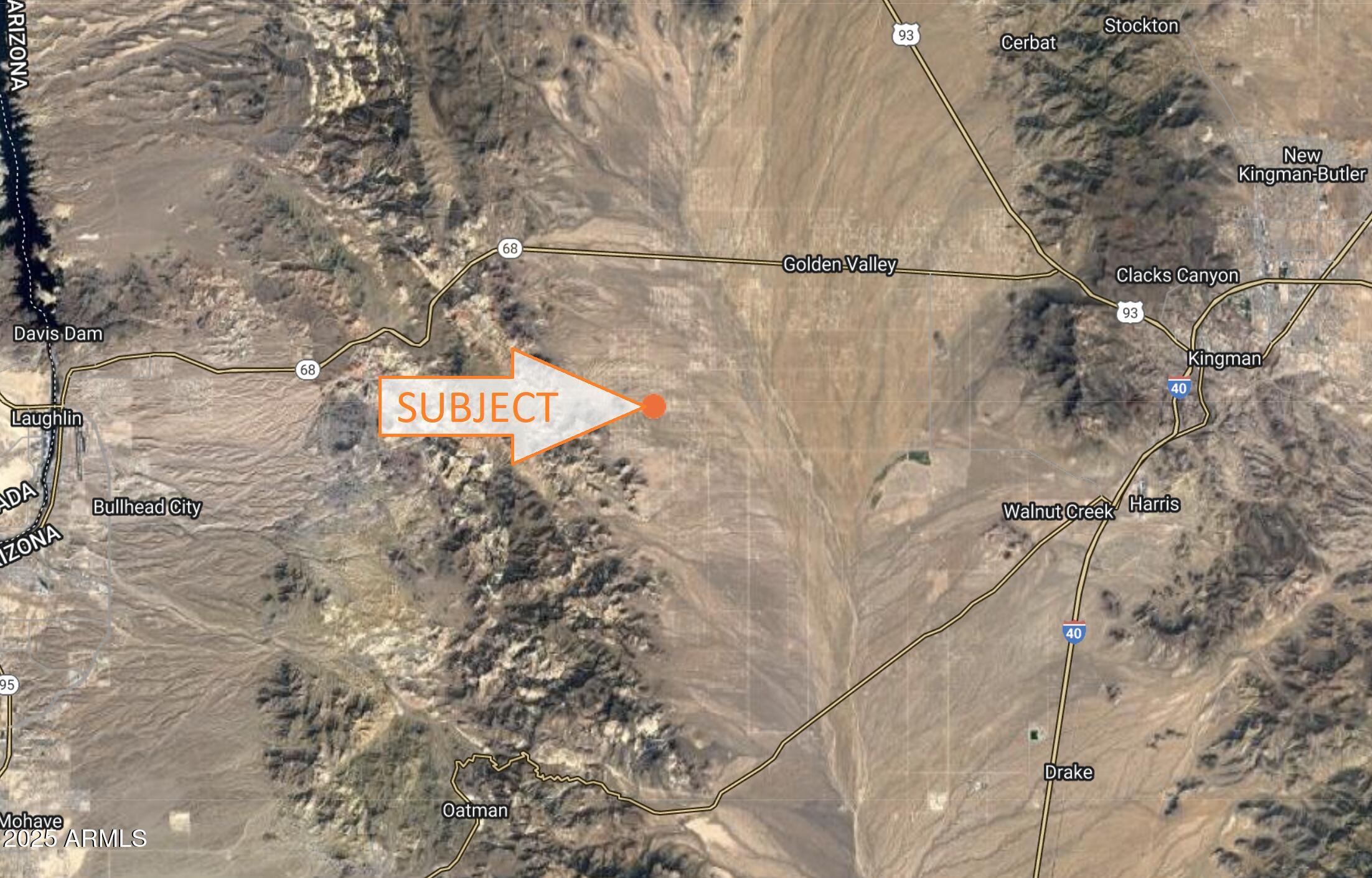 a view of a dry yard with wooden fence