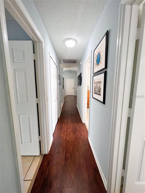 307 Diamond Ridge Boulevard Auburndale, FL 33823 - Photo 12 of 31 a view of a hallway with wooden floor and stairs