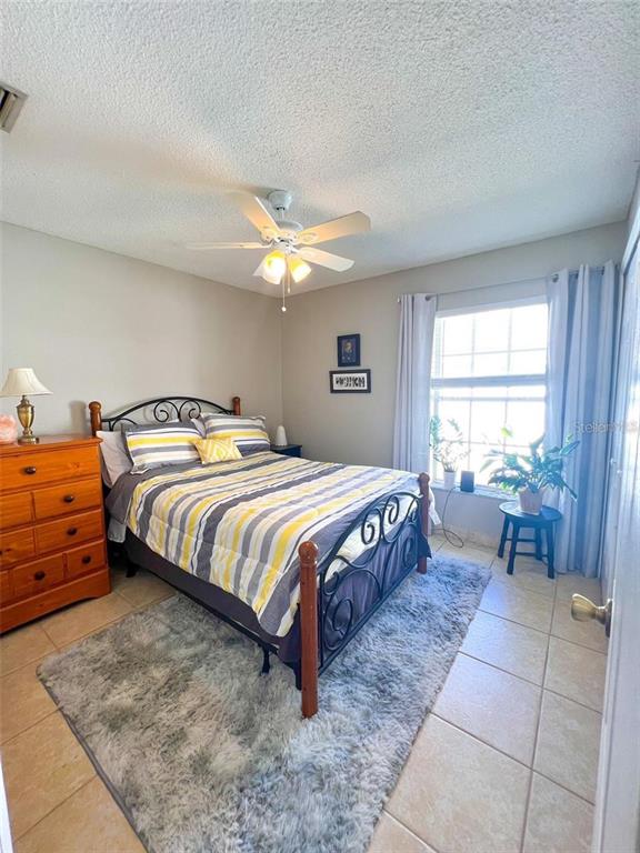 307 Diamond Ridge Boulevard Auburndale, FL 33823 - Photo 13 of 31 a bedroom with a bed and a table with chair