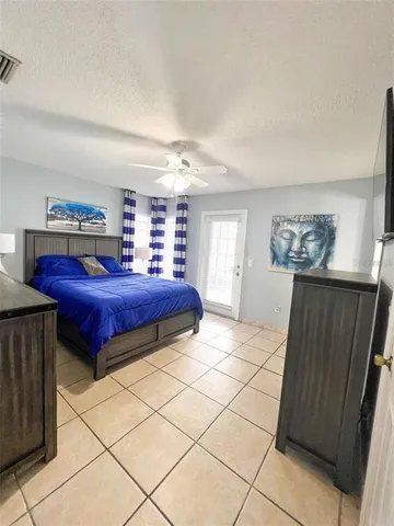 a spacious bedroom with a bed and a cabinets