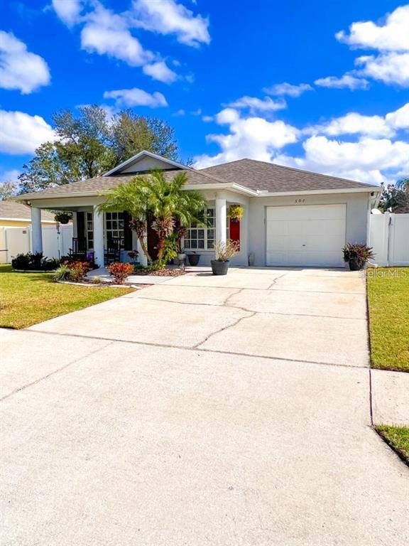 307 Diamond Ridge Boulevard Auburndale, FL 33823 - Photo 2 of 31 a front view of a house with a yard and garage