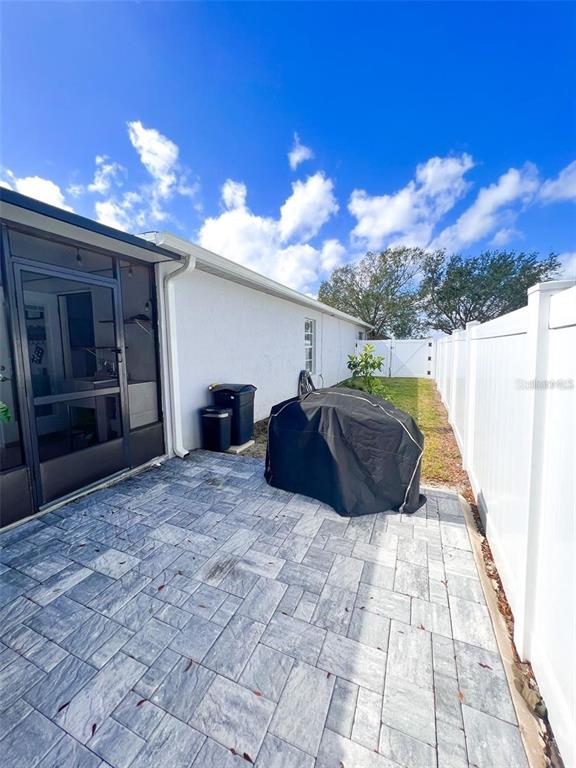 307 Diamond Ridge Boulevard Auburndale, FL 33823 - Photo 29 of 31 a spacious bedroom with a bed and a chandelier