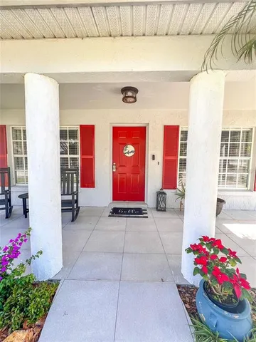 a view of front door of house and flowers