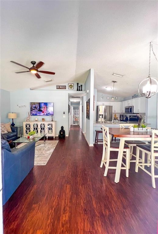 307 Diamond Ridge Boulevard Auburndale, FL 33823 - Photo 5 of 31 a living room with furniture dining table and wooden floor