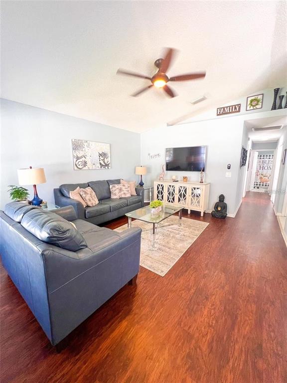 307 Diamond Ridge Boulevard Auburndale, FL 33823 - Photo 7 of 31 a living room with furniture and a wooden floor