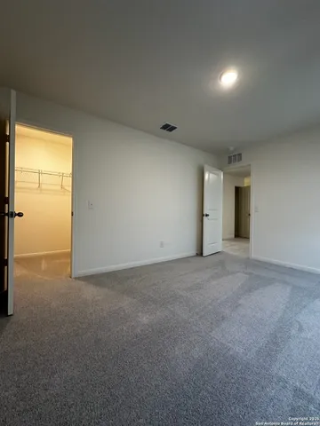 a view of an empty room with a closet