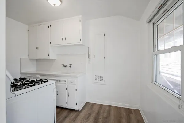 a kitchen with a sink stove and refrigerator