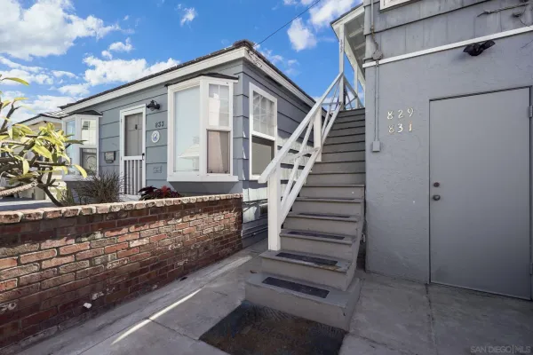 a front view of a house with wooden stairs
