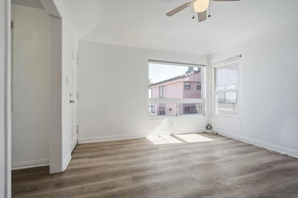 a view of wooden floor and windows in a room