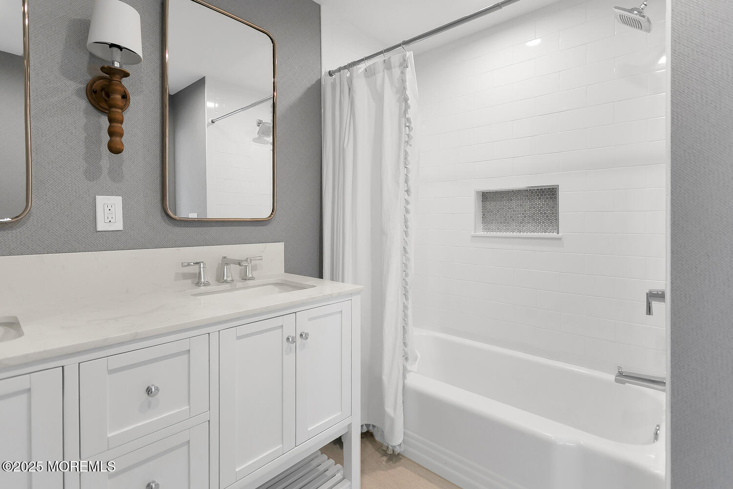306 Ocean Road Spring Lake, NJ 07762 - Photo 31 of 58 a bathroom with a granite countertop sink a mirror a vanity and a bathtub