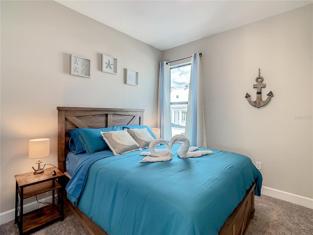 208 Villa Domani Circle Davenport, FL 33896 - Photo 12 of 26 a bedroom with a bed and window