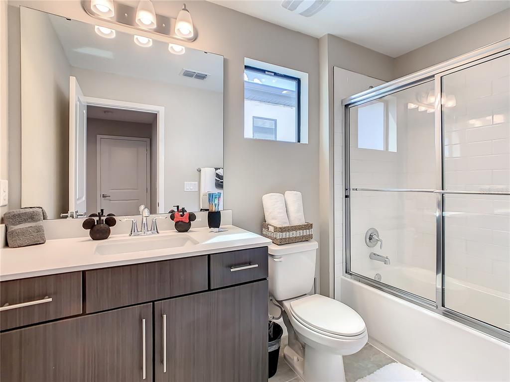 208 Villa Domani Circle Davenport, FL 33896 - Photo 14 of 26 a bathroom with a sink toilet and shower