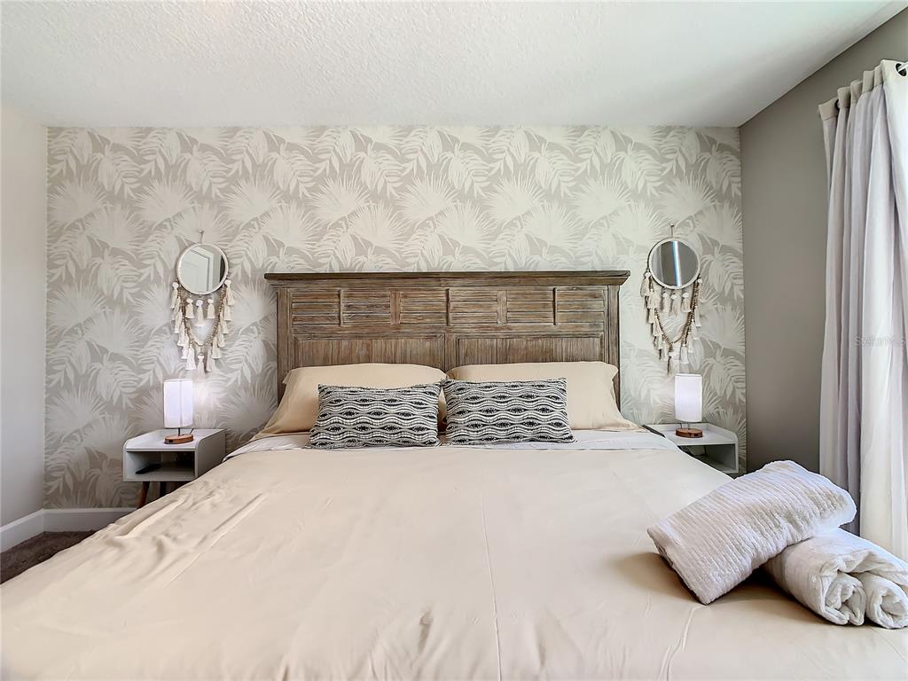 208 Villa Domani Circle Davenport, FL 33896 - Photo 15 of 26 a bedroom with bed and window