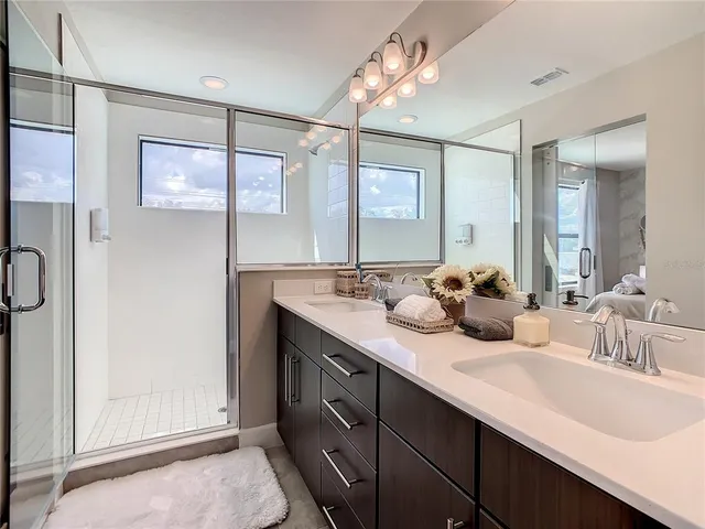 a bathroom with a double vanity sink mirror and toilet