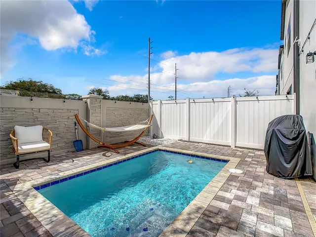 a view of a backyard with sitting area