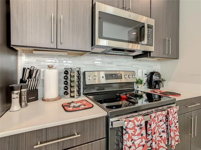 a kitchen with stainless steel appliances granite countertop a stove and a microwave